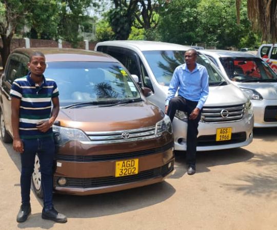 Mechanic performing maintenance on a luxury vehicle